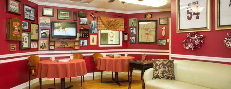 Cozy common area with red walls and historical decor
