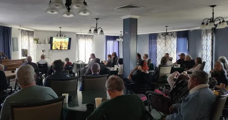 Residents enjoying a movie in a common area