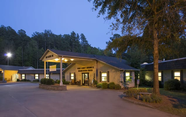 Exterior view of a senior living facility at dusk