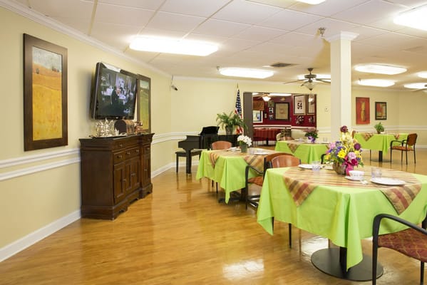 Bright dining room with green table settings and decor