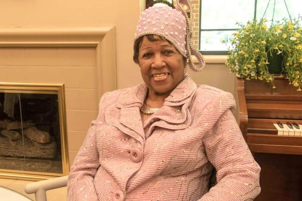 Resident smiling in a beautifully decorated outfit