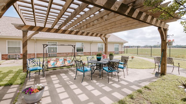 Outdoor seating area with swing under a pergola