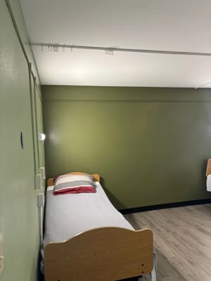 Interior view of a resident room with a bed