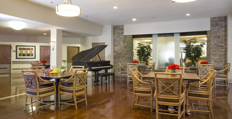 Interior view of a social lounge with seating and piano