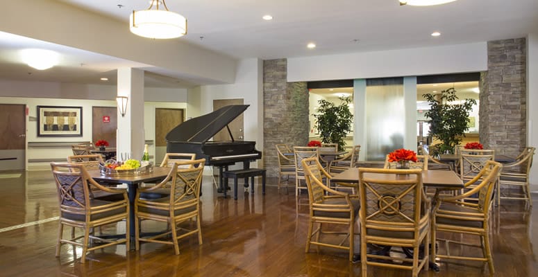 Interior view of a social lounge with seating and piano