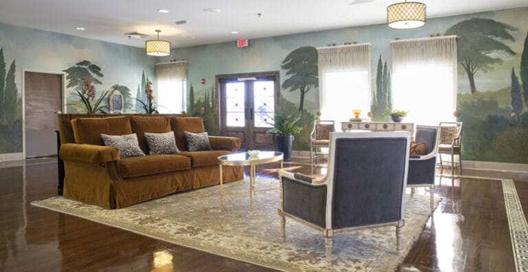 Cozy lounge area with a stylish sofa and decorative mural