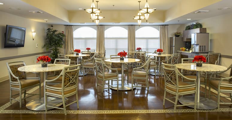 Bright dining area with tables and flowers