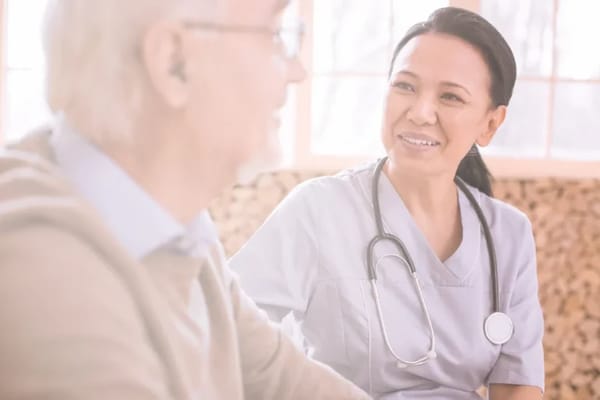 Caregiver smiling and interacting with a senior resident
