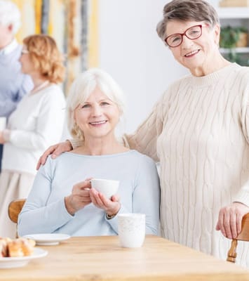 Residents enjoying coffee and conversation in a cozy setting