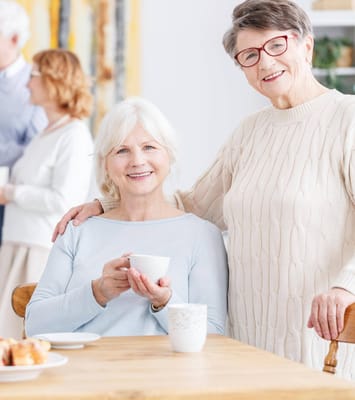 Residents enjoying coffee and conversation in a cozy setting