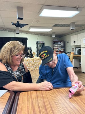 Resident and staff member engaging in an activity