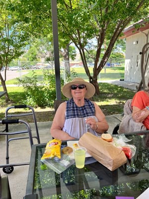 Resident enjoying a snack outdoors under shade