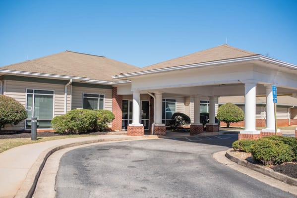 Front entrance of assisted living facility with semi-circular drive