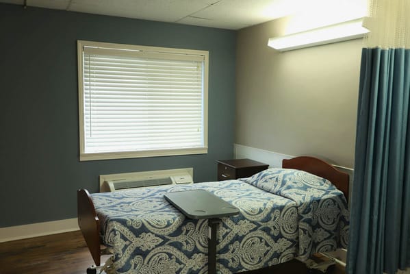 Private resident room with a bed and window