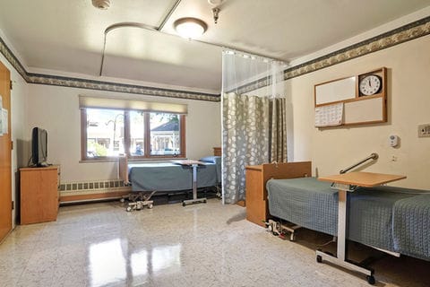 A well-equipped resident room in a nursing facility