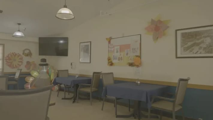Dining area with tables and decor in a senior living facility