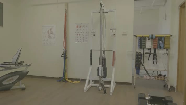 Rehabilitation gym with exercise equipment and therapy charts
