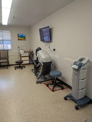 A therapy room with medical equipment and seating