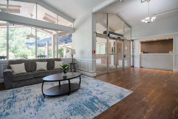 Bright common area with seating and natural light