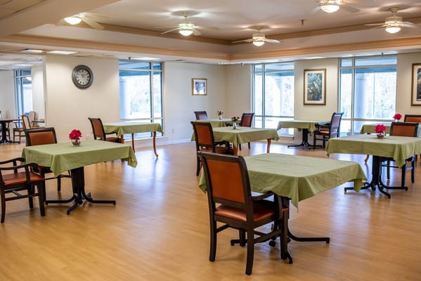 Bright dining room with tables set for meals