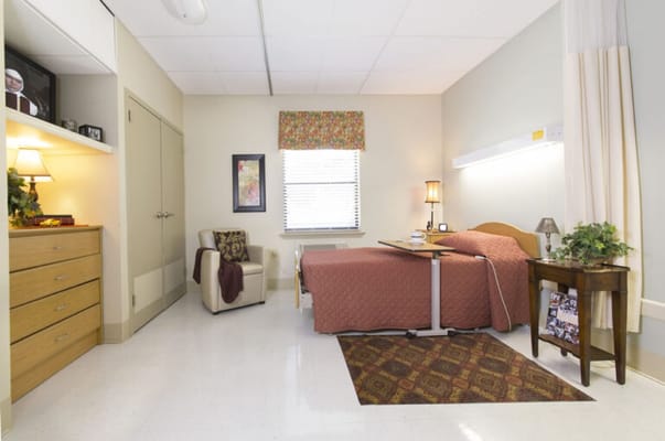 Cozy private resident room with a bed and seating