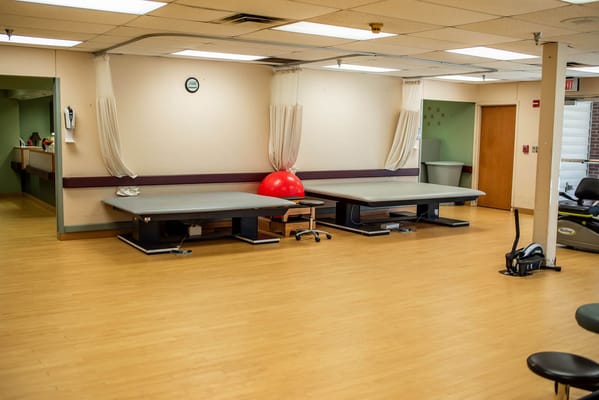 Rehabilitation area with exercise equipment and mats