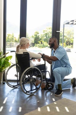 Healthcare worker assisting a resident in a wheelchair