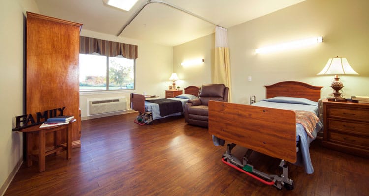 Cozy shared resident room with two beds and furniture