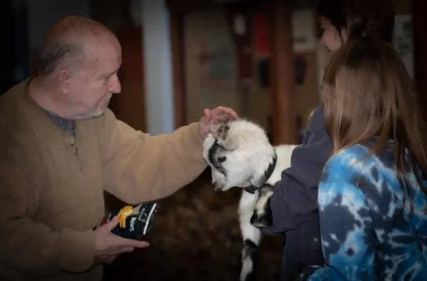 Resident interacting with a pet during an activity