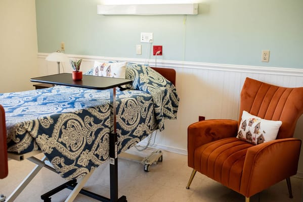 Cozy resident room with a bed and chair