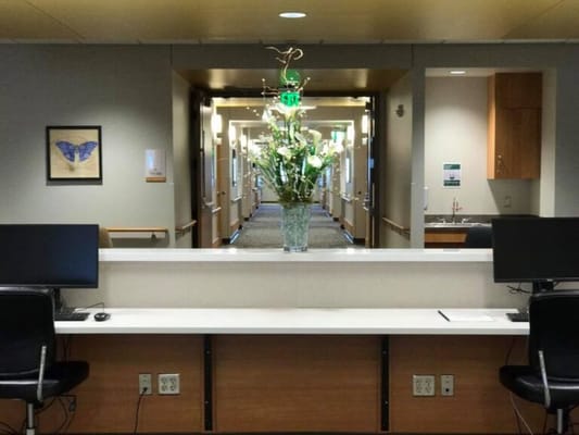 Reception area with a floral arrangement and computer stations