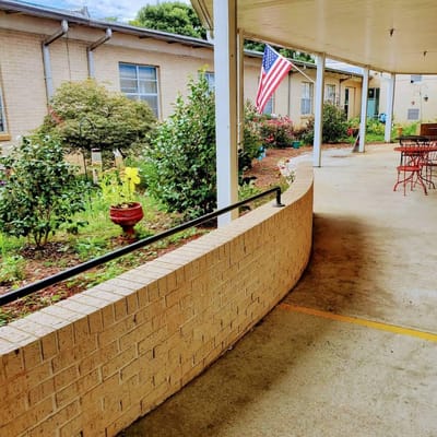 Outdoor pathway with gardens and seating area