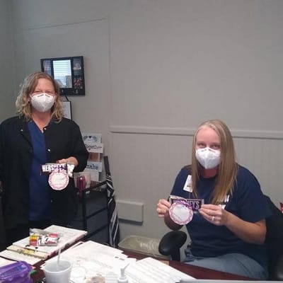 Staff members holding community celebration items