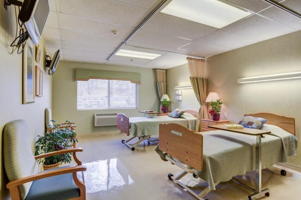 Two resident beds in a shared room with natural light
