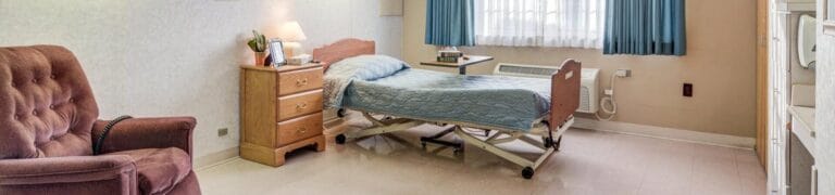 Bright private resident room with bed and chair