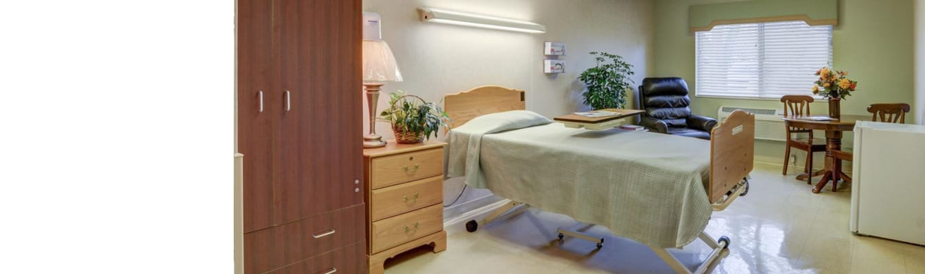 Private resident room with a bed and seating area