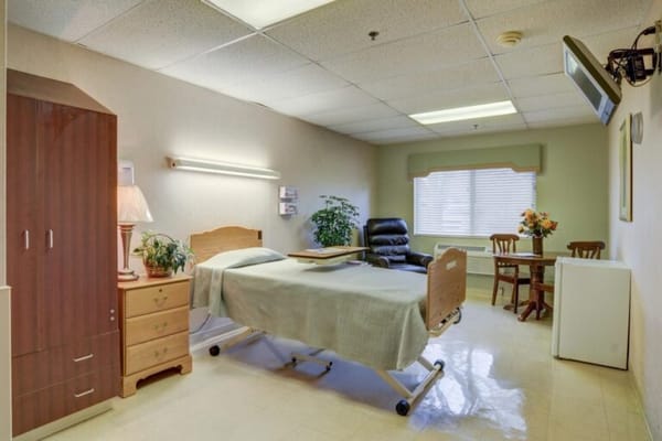 A well-furnished resident room in a nursing facility