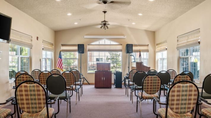 Interior of a community room with chairs and a podium