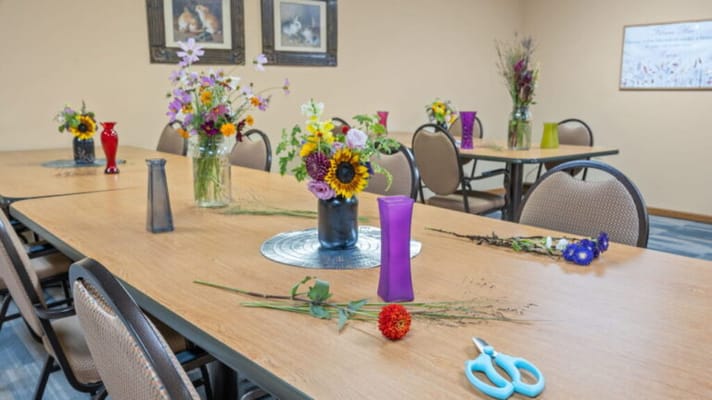 Activity room with flower arranging supplies and decorated tables