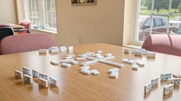 Dominoes laid out on a table in an activity room