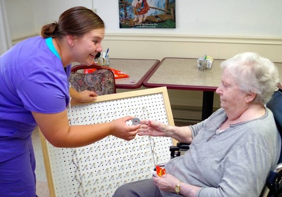 Staff assisting a resident with an activity