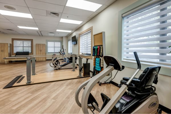 Rehabilitation gym with exercise equipment and therapy area