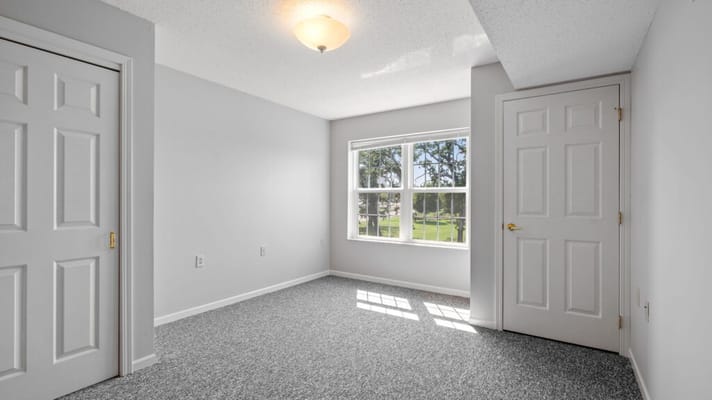 Bright, empty resident room with window