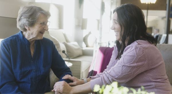 Two women smiling and engaging in conversation