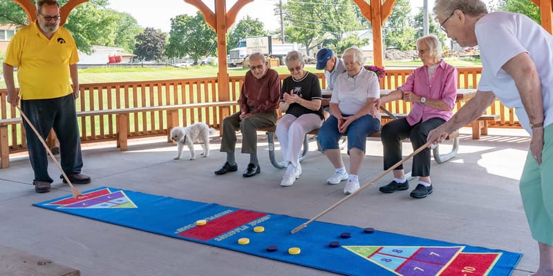 Residents engaging in a game outside under a shelter