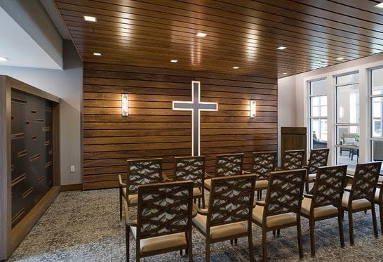 Interior chapel with wooden paneling and seating