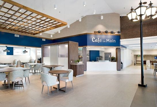 Bright dining area with modern furniture and café sign