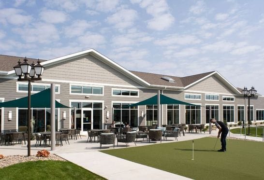 Residents enjoying outdoor putting green area