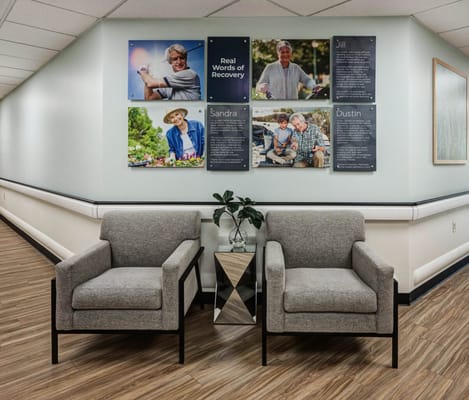 Two chairs in a common area with resident photos