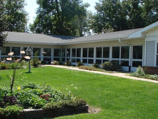 Exterior view of assisted living facility with garden